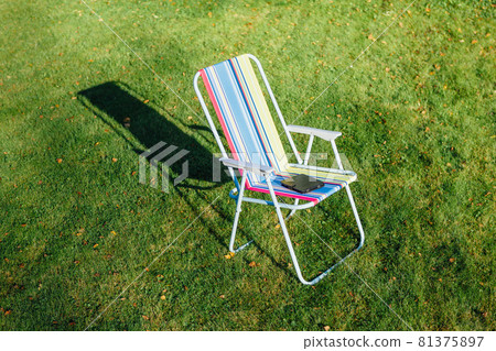 garden chair on green lawn background garden chair on green lawn background 81375897