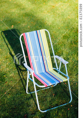 garden chair on green lawn background garden chair on green lawn background 81375899