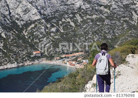 Female hiker looking at the sea and mountains from the top of the mountain 81376098