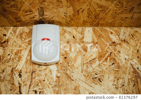 motion detector (sensor) in action, osb wall background motion detector (sensor) in action, osb wall background 81376297