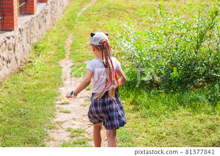 Child schooler with smartwatch running outdoor park. Kid using smartwatches active lifestyle sport. Schoolgirl walking Child schooler with smartwatch running outdoor park. Kid using smartwatches active lifestyle sport. Schoolgirl walking 81377841