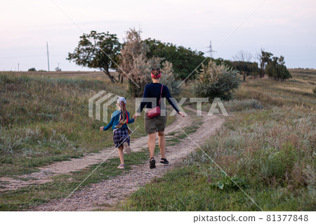 Mother and daughner running back view. Happy family concept. 81377848