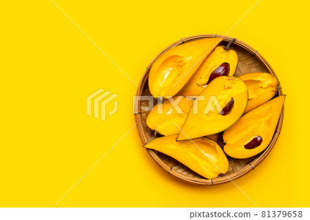 Canistel fruit in bamboo basket on yellow background. Canistel fruit in bamboo basket on yellow background. 81379658
