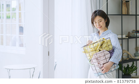 Young woman with laundry 81379758