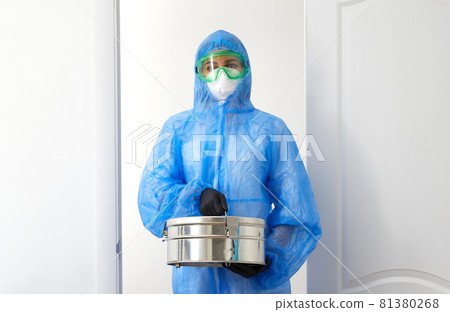 Unrecognizable medical scientist in protective uniform opening doors and entering laboratory room holding metal case with samples Unrecognizable medical scientist in protective uniform opening doors and entering laboratory room holding metal case with samples 81380268