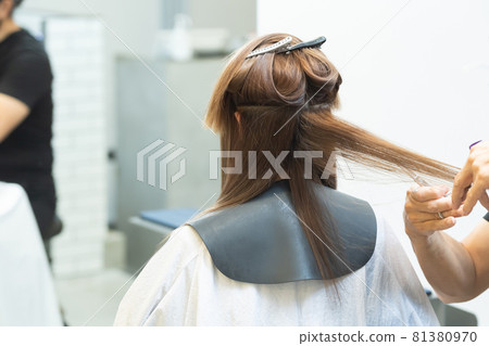 Hands of a stylist who cuts women's hair at a hair salon Hands of a stylist who cuts women's hair at a hair salon 81380970