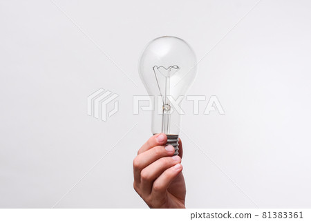 incandescent bulb in hand on a white background. mock up 81383361
