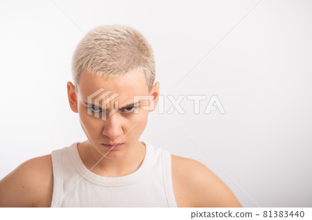 Displeased young caucasian woman with short haircut on white background. Displeased young caucasian woman with short haircut on white background. 81383440