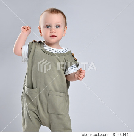 Portrait of a cute baby 12 months old in a green Portrait of a cute baby 12 months old in a green 81383441