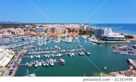 A view from the sky of the tourist Portuguese town of Vilamoura, with Yachts and sailboats moored in the port on the dock. A view from the sky of the tourist Portuguese town of Vilamoura, with Yachts and sailboats moored in the port on the dock. 81383496