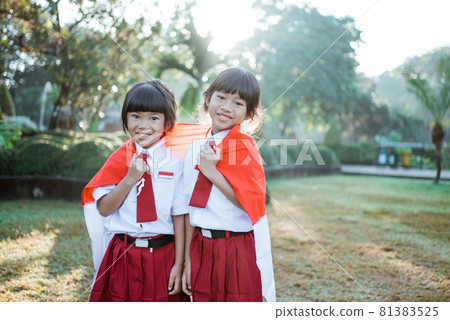 indonesian school student holding flag during independence day. indonesian school student holding flag during independence day. 81383525
