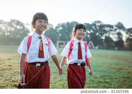 female asian primary first grader student walk together female asian primary first grader student walk together 81383596
