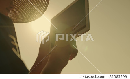 agriculture, farmer is actively working in a tablet in the glare of the sun in a clear sky, modern small computer for business, concept, agronomist's dream of harvesting on farm, doing business online agriculture, farmer is actively working in a tablet in the glare of the sun in a clear sky, modern small computer for business, concept, agronomist's dream of harvesting on farm, doing business online 81383599