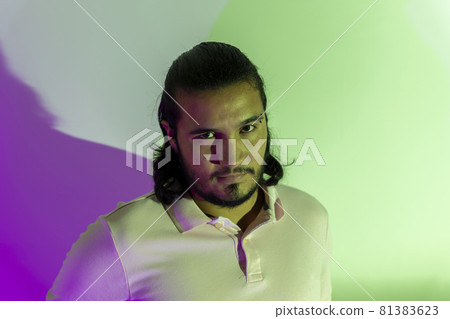 gay man with colored lights looking at camera 81383623