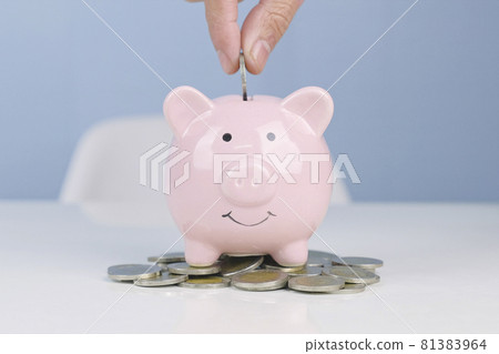 Man hand putting money coin into piggy for saving money, wealth and financial concept. Man hand putting money coin into piggy for saving money, wealth and financial concept. 81383964