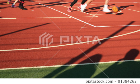 Street basketball championship. Playing on a rubberized field. Outdoor sports banner. Webb banner about healthy life. Sport textured wallpaper. Red rubber ground for competition. Basketball team  81384262