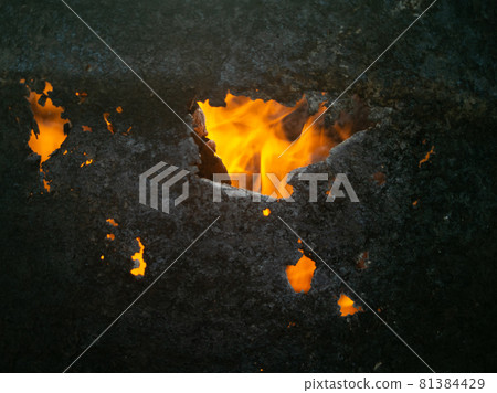 building on fire close up. fiery fires. bright fire through a burnt hole. fires concept building on fire close up. fiery fires. bright fire through a burnt hole. fires concept 81384429