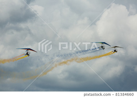 Ultralight trikes performing in sky on air show Ultralight trikes performing in sky on air show 81384660