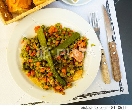 Stewed different vegetables and bacon served at plate 81386111