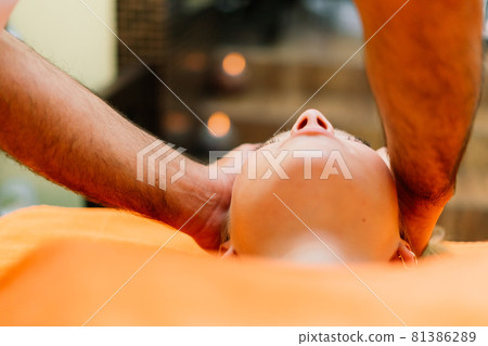 An attractive latin american woman lying down on a massage bed at a spa 81386289