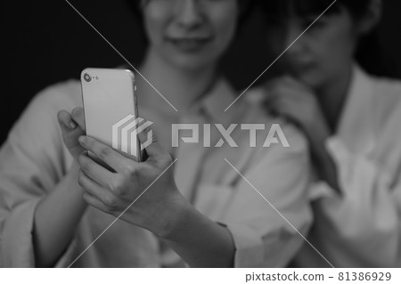 Woman taking pictures with a smartphone Woman taking pictures with a smartphone 81386929