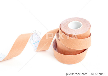 Pile of lifting or kinesio tape rolls on white surface 81387045