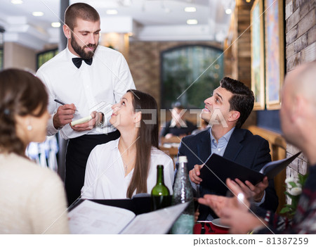 Employee waiter man taking order from guests Employee waiter man taking order from guests 81387259
