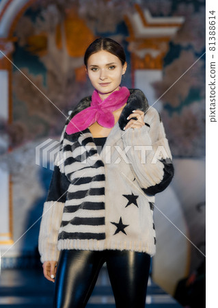 Fashion model walks on runway in fur coat Fashion model walks on runway in fur coat 81388614