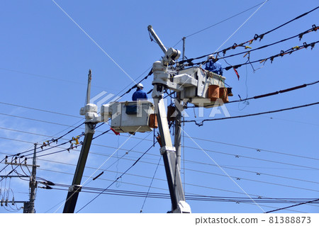 Electrical work on utility poles performed by two aerial work vehicles 81388873