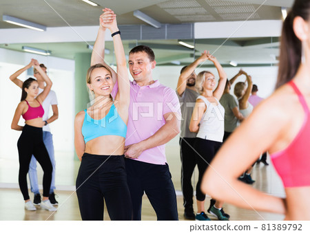 Group of young adults dancing salsa in club 81389792