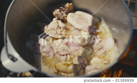 Meat is fried in a pot over an open fire on a camping trip, outdoor recreation with cooking, food on the fire on a day off, a traditional dish with meat, cuisine in extreme conditions 81389939
