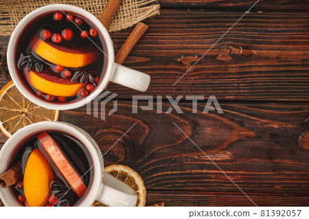 Christmas composition with hot mulled wine in rustic cup 81392057