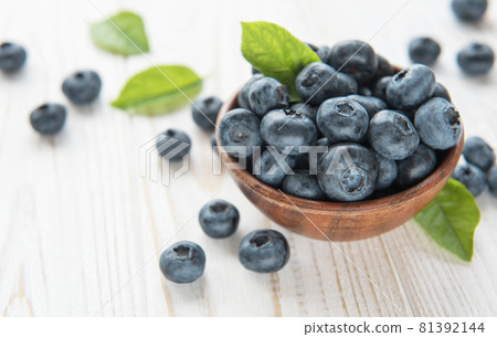 Blueberries on old wooden background Blueberries on old wooden background 81392144