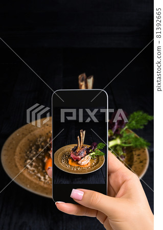 A young woman taking photo of food on smartphone, photographing meal with mobile camera 81392665