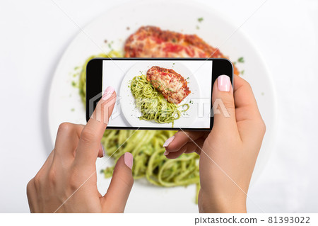 A young woman taking photo of food on smartphone, photographing meal with mobile camera 81393022