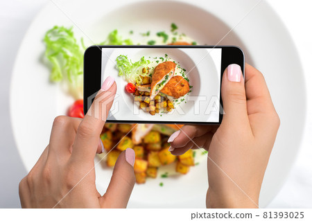 A young woman taking photo of food on smartphone, photographing meal with mobile camera 81393025