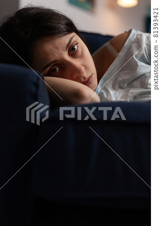 Traumatised depressed woman crying lying on sofa Traumatised depressed woman crying lying on sofa 81393421