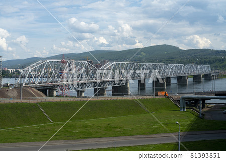 Railway bridge over the river in an industrial city. 81393851