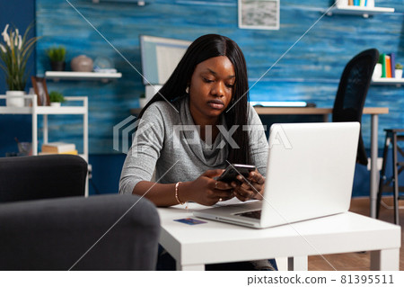 African american student holding phone in hands texting message chatting with group friends African american student holding phone in hands texting message chatting with group friends 81395511