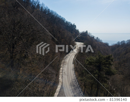 Aerial autumn road from above view of cars on a zig zag road. Season forest road landscape. Mountain forest road in autumn. Aerial autumn road from above view of cars on a zig zag road. Season forest road landscape. Mountain forest road in autumn. 81396140