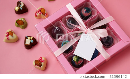 Chocolate candy. Pink gift box with handmade chocolates on pink Chocolate candy. Pink gift box with handmade chocolates on pink 81396142