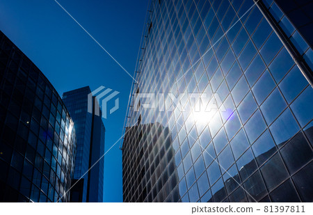 The sun's rays are reflected in the glass of a modern office skyscraper The sun's rays are reflected in the glass of a modern office skyscraper 81397811