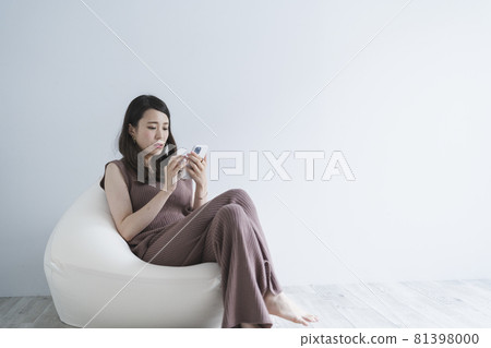 Woman using a smartphone Woman using a smartphone 81398000