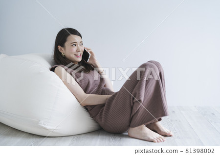 Woman using a smartphone Woman using a smartphone 81398002