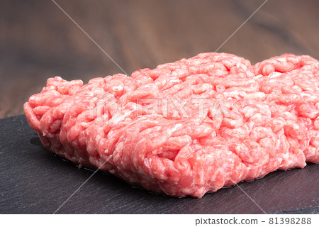 Close-up of ground beef on a black slate stone board. 81398288