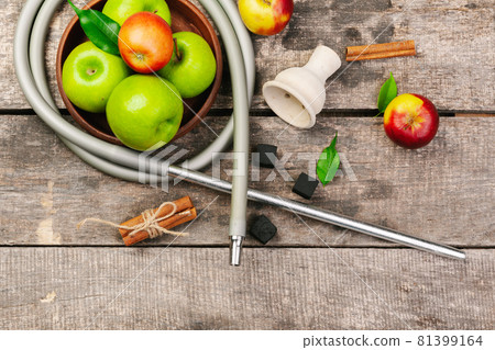 Parts of hookah and fruits on wooden background Parts of hookah and fruits on wooden background 81399164