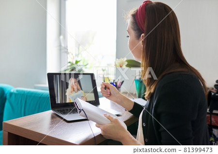Female teacher at home with laptop on virtual meeting with teenage student 81399473