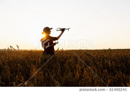 Woman farmer with drone  81400241