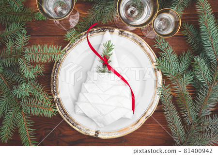 Christmas table setting with pine tree branches and decorations top view Christmas table setting with pine tree branches and decorations top view 81400942