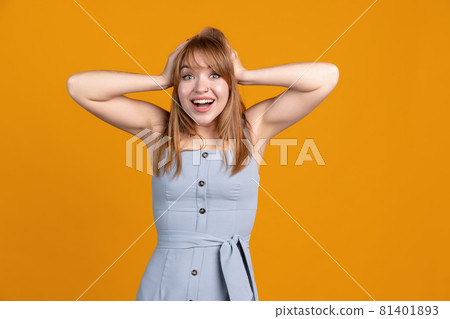Horizontal portrait of young beautiful girl isolated on yellow studio background. Concept of human emotions, facial expression, youth, sales, ad. Horizontal portrait of young beautiful girl isolated on yellow studio background. Concept of human emotions, facial expression, youth, sales, ad. 81401893